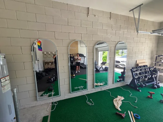 True Home Connections mirror installation on an exposed concrete-block wall