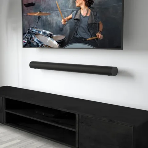 Soundbar mounted on the wall below a television
